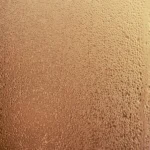A detailed shot of dewdrops creating a pattern on a glass surface with warm lighting.